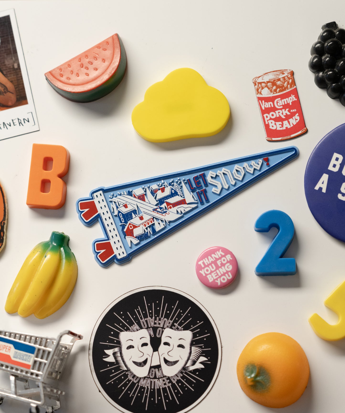 Collection of various colorful items including letters, a number, and a flag on a white background.