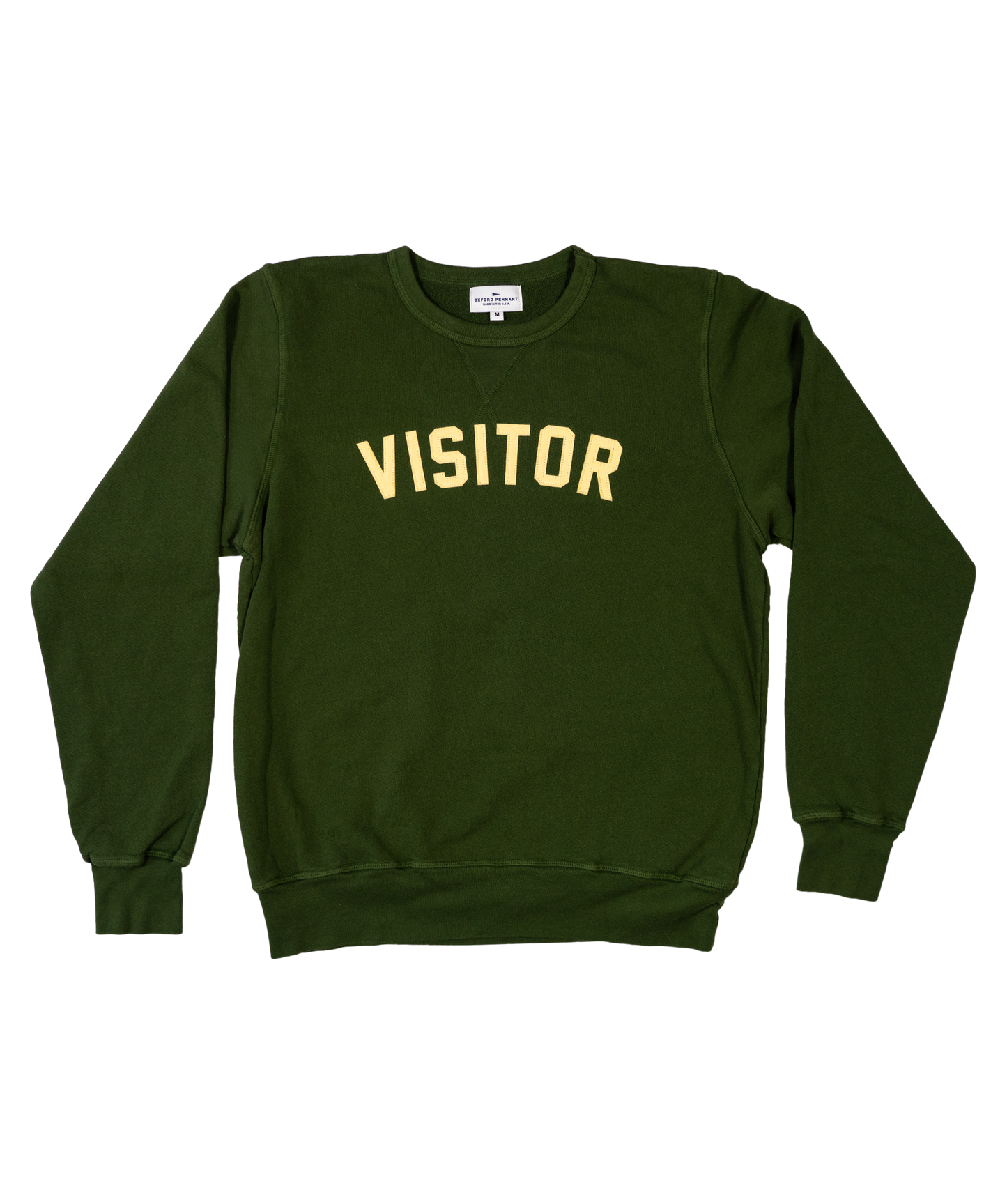 Green medium crewneck sweater. Curved lettering stitched that reads "VISITOR".