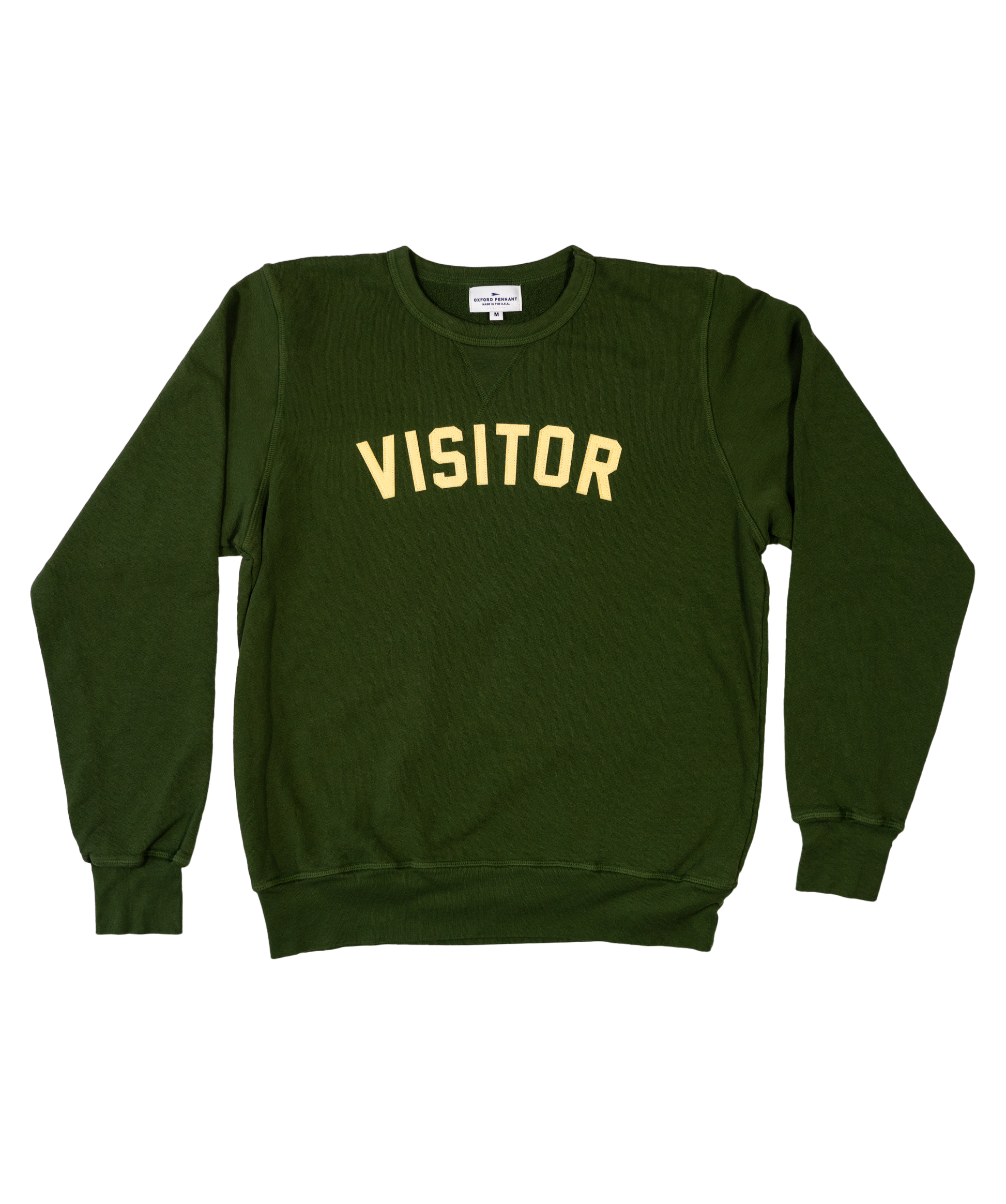 Green medium crewneck sweater. Curved lettering stitched that reads "VISITOR".