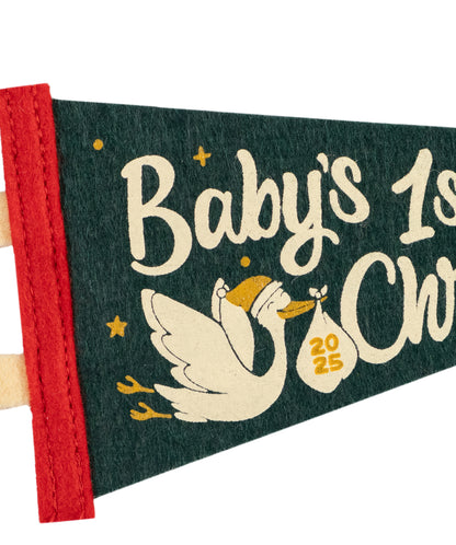 Baby's First Christmas pennant with stork and baby bag design on a green background
