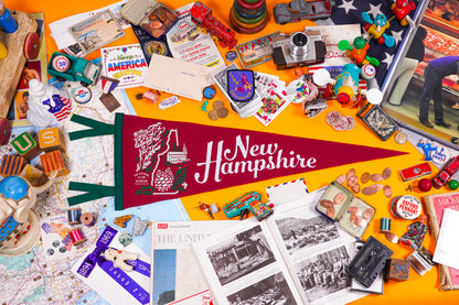 Collection of New Hampshire-themed items including a flag, photos, and souvenirs on a yellow background.